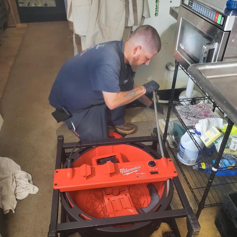 Drain snake in commercial kitchen drain cleaning