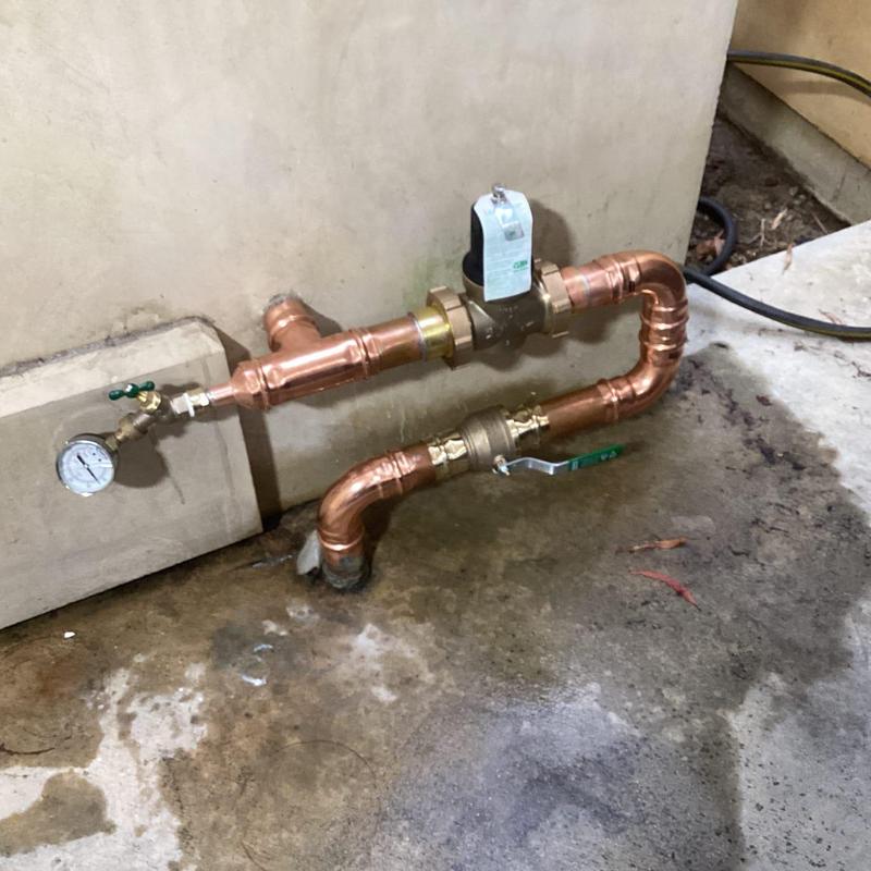 Copper water service pipes with regulator and ball valve installed