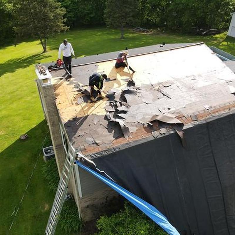 Flat roof tear-off and removal by three workers