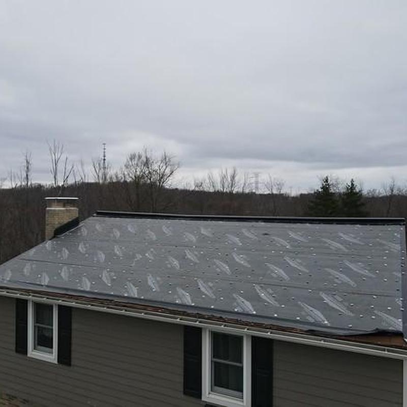 Metal roof underlayment installation on residential home
