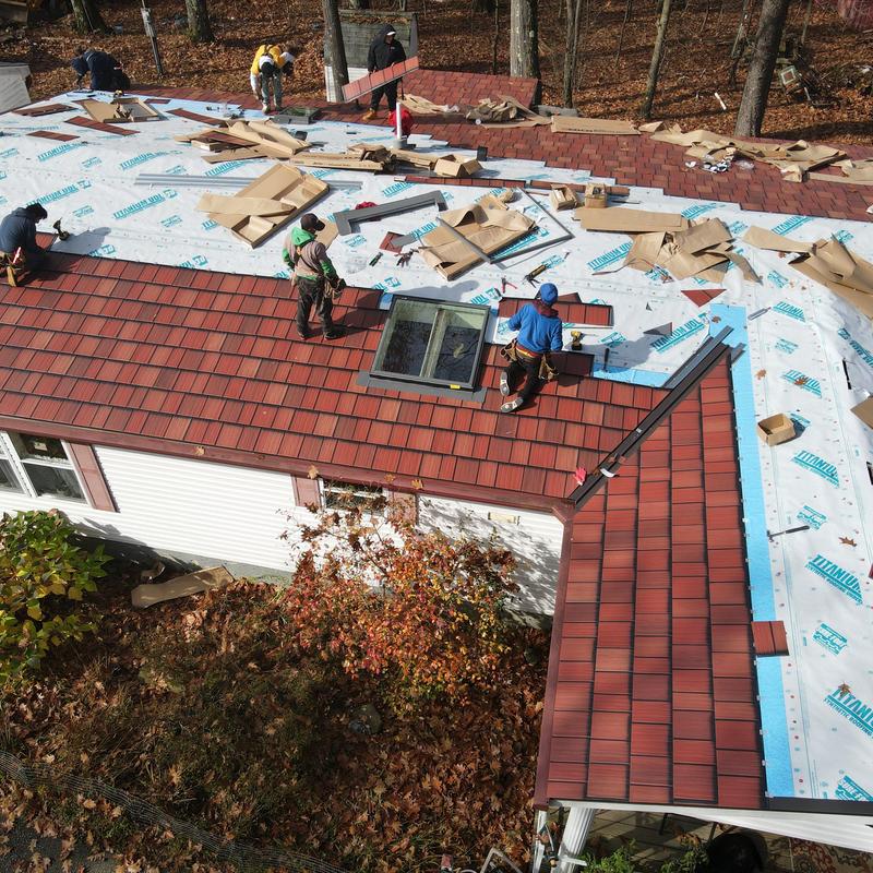 Steel Country metal roof installation with skylight