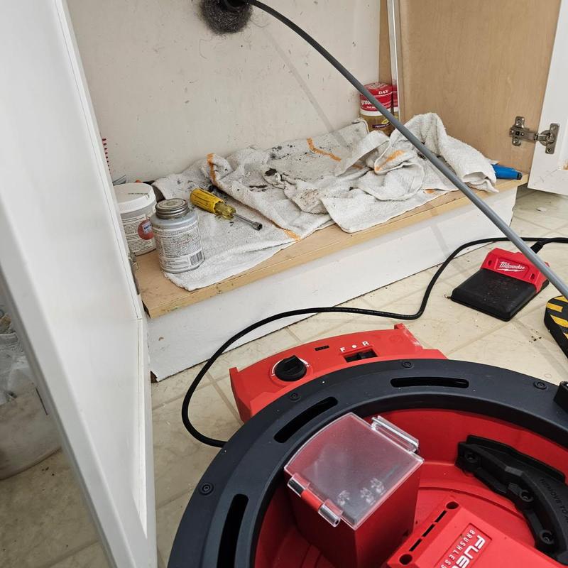 Lavatory drain line snaking with drain cleaning machine