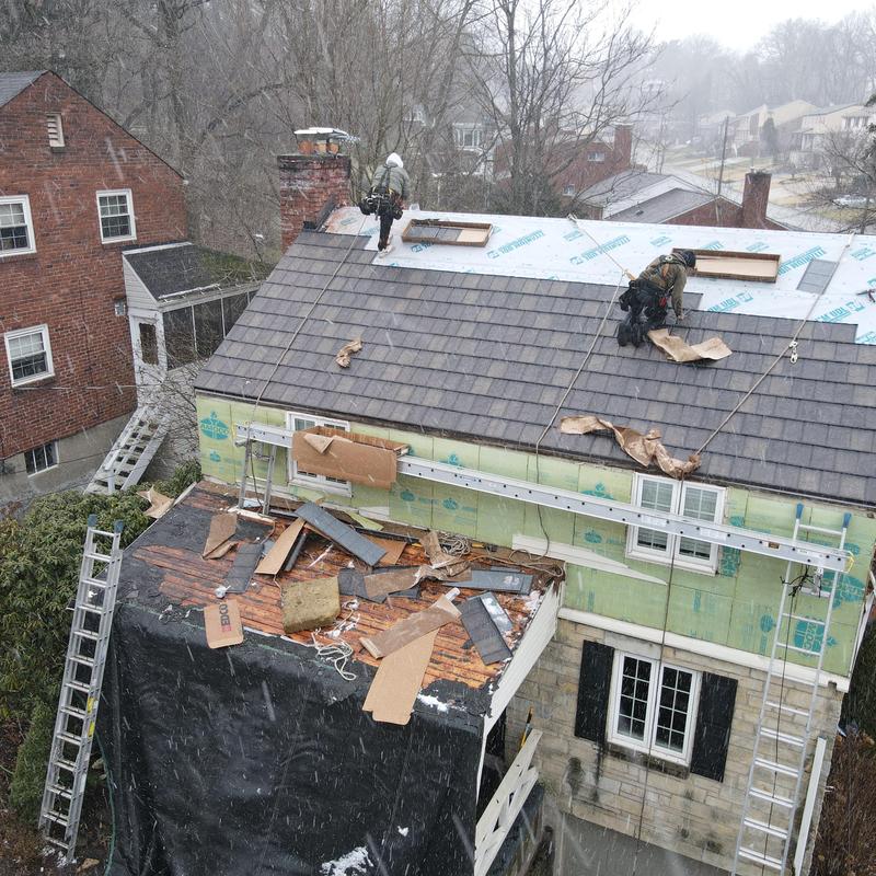 Slate roofing installation with safety harnesses in Pittsburgh