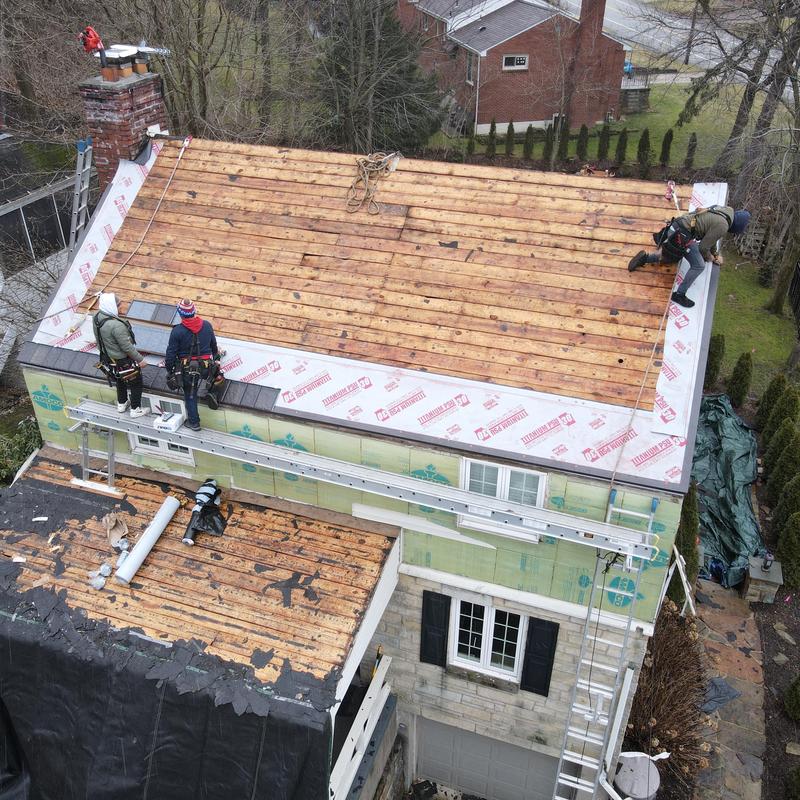 Wood roof decking installation with safety harnesses