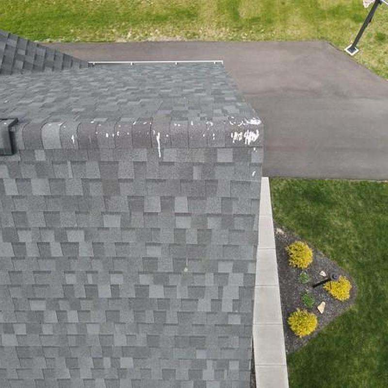 Gray roof shingles with visible wear at the edge