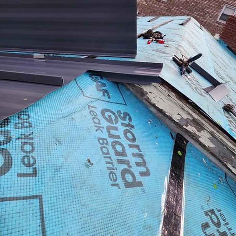 Striated standing seam metal roof installation with leak barrier