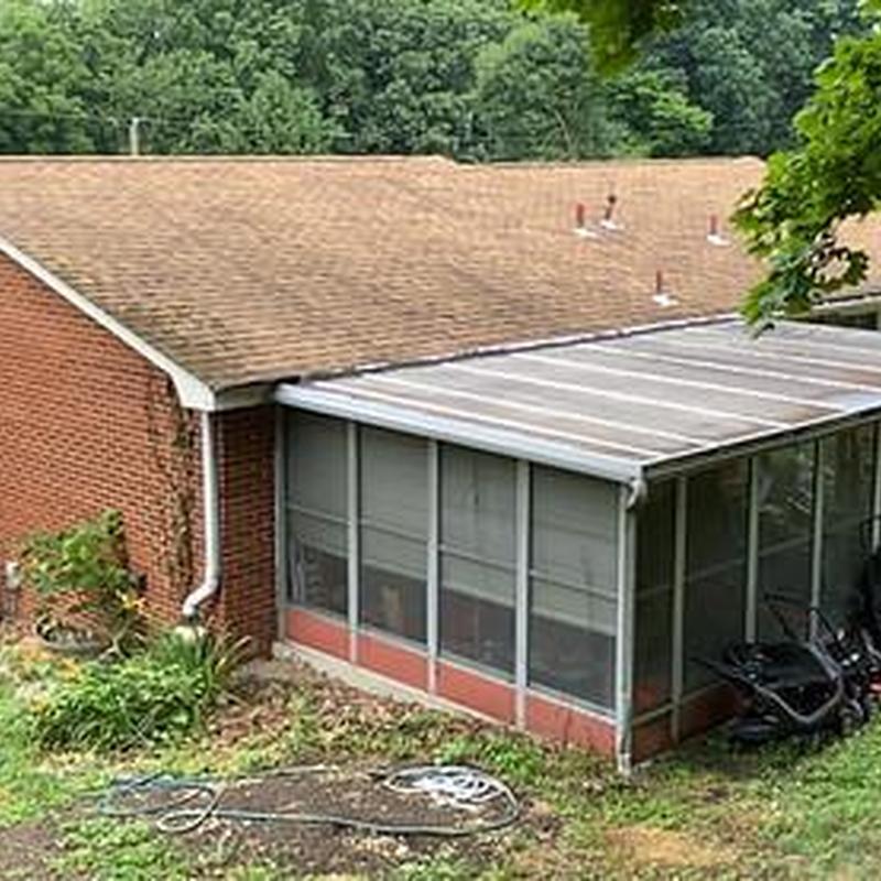 Screened porch enclosure with aluminum roof panels
