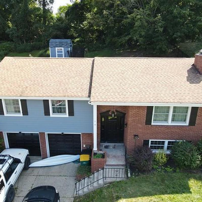 Asphalt shingle roof on split-level home with chimney