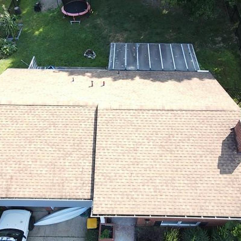 Asphalt shingle roof installation on suburban home