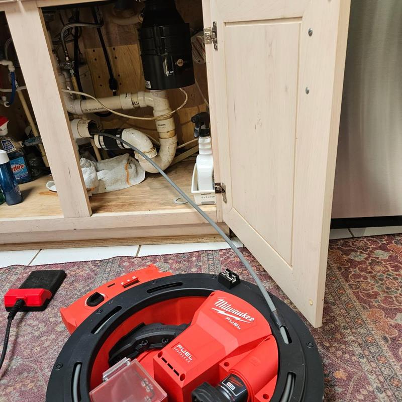 Kitchen drain line with Milwaukee drain cleaning tool