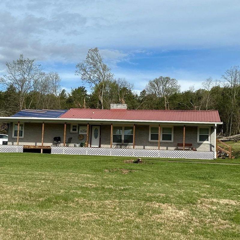 Metal roof with solar panels on rural home