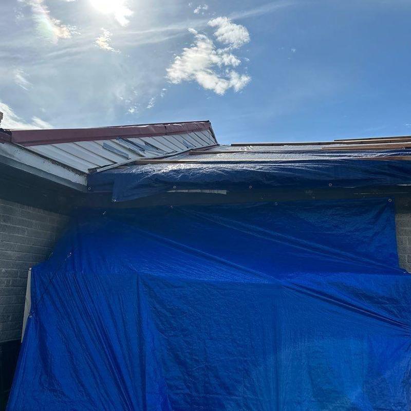 Roof tarp covering storm damage after hail and wind