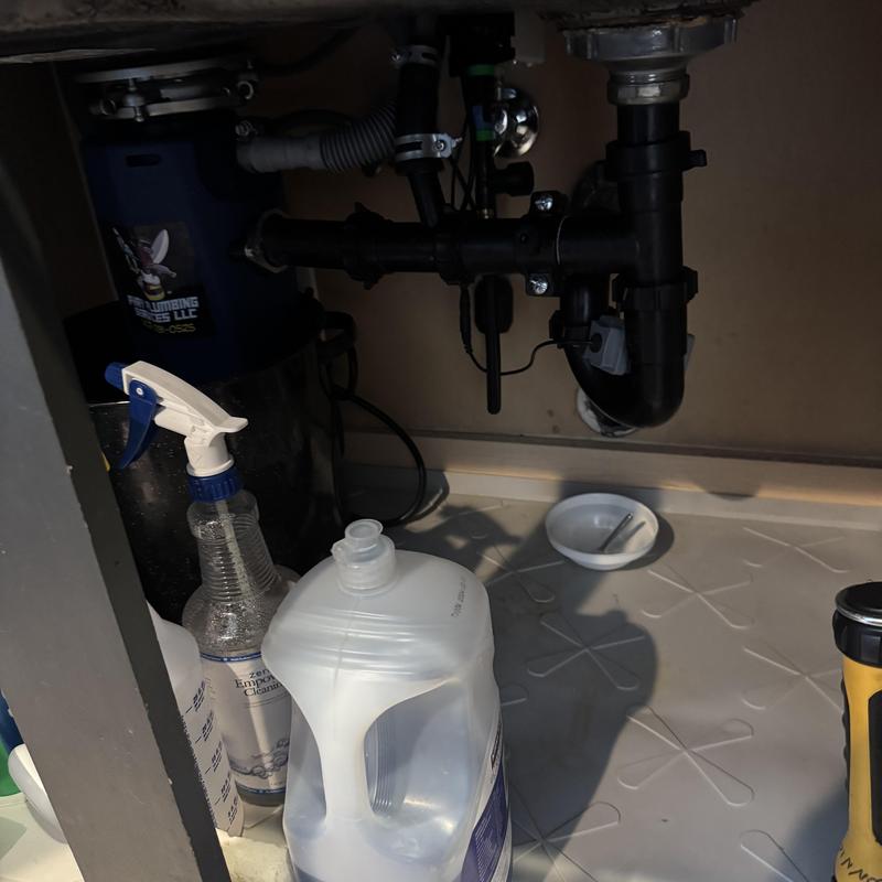 Under-sink plumbing pipes with leak cleanup tools