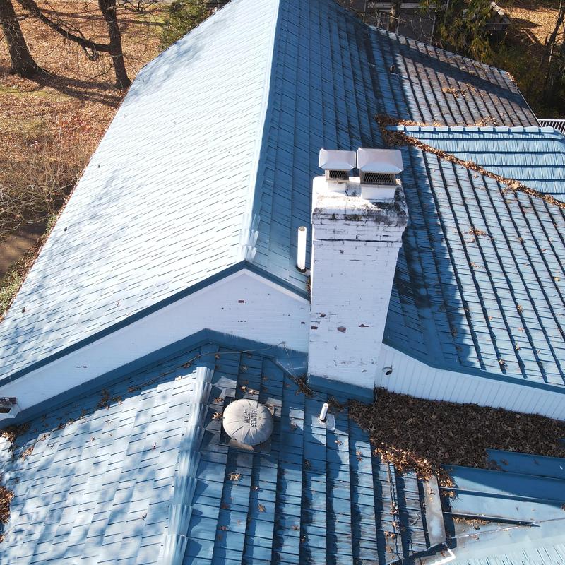 Steel metal shingle roof with chimney and ventilation fans