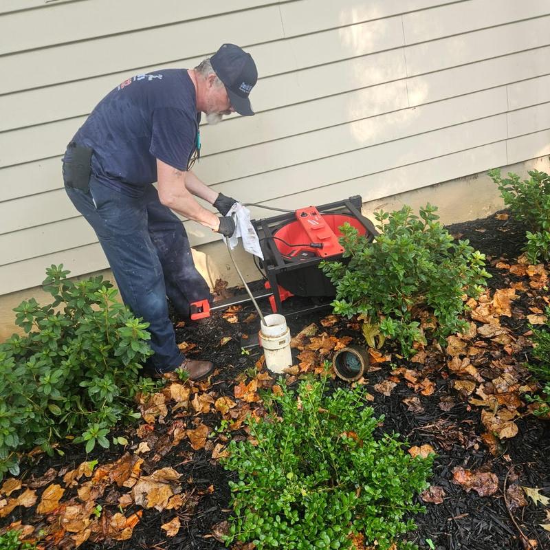 Main drain line clearing with auger near house exterior