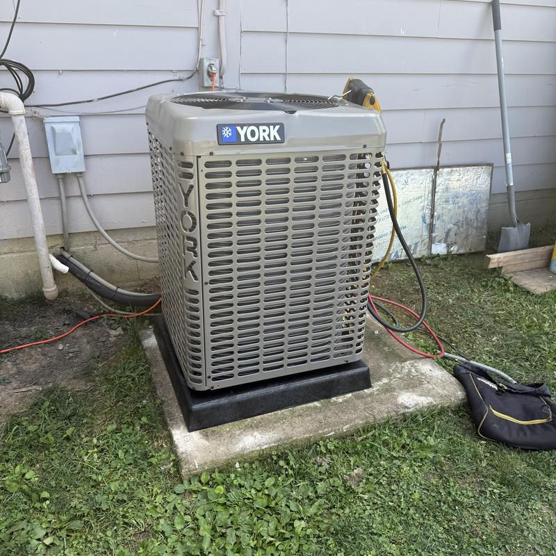 York air conditioner condenser unit on pad outdoors