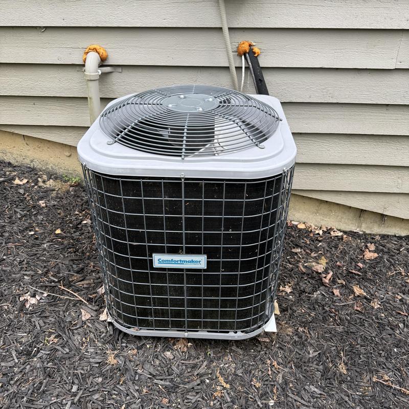 Outdoor air conditioner unit with protective grill