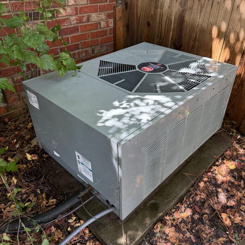 Air conditioner condenser unit outdoors on pad