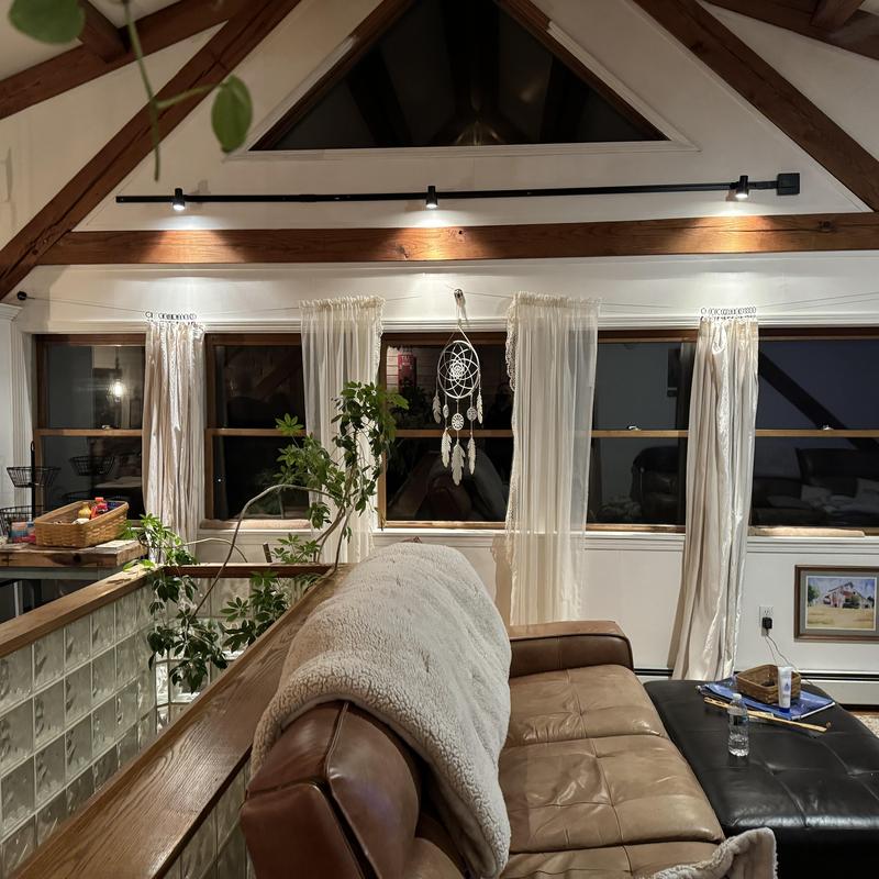 Track lighting installation above living room windows