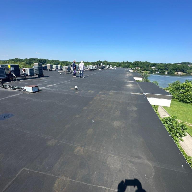 Flat roofing surface with HVAC units and inspection