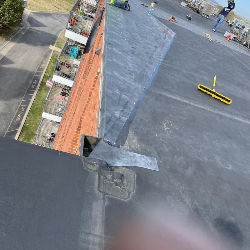 Roofing membrane seam with storm damage repairs