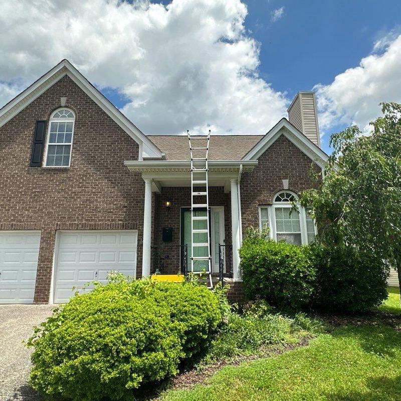 Roof shingles inspection with ladder setup on house