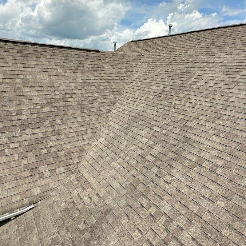 Storm-damaged roof shingles and valley inspection