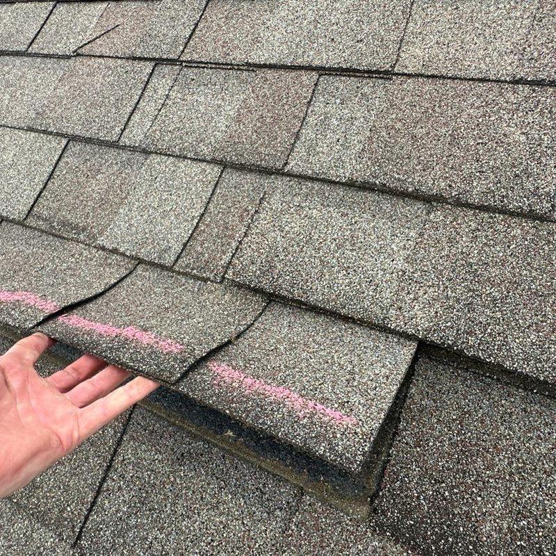 Asphalt shingles with storm damage inspection marks