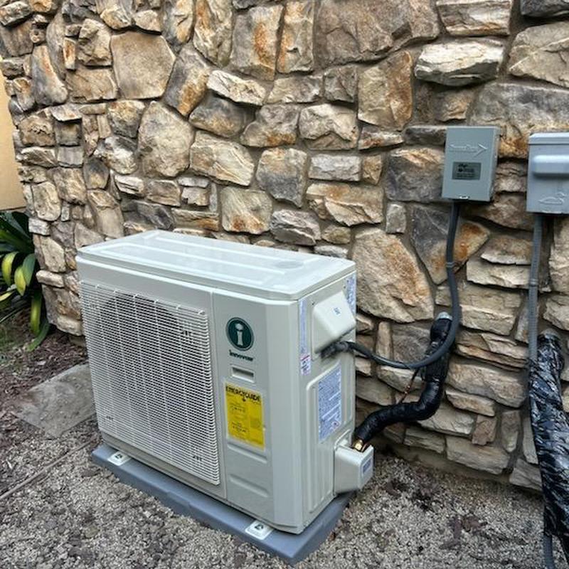 Innovair heat pump unit installed on stone wall
