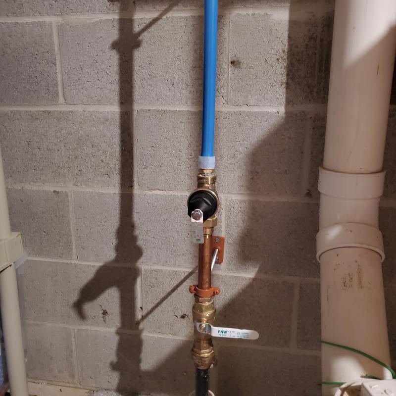 Pressure reducing valve and piping installed on basement wall