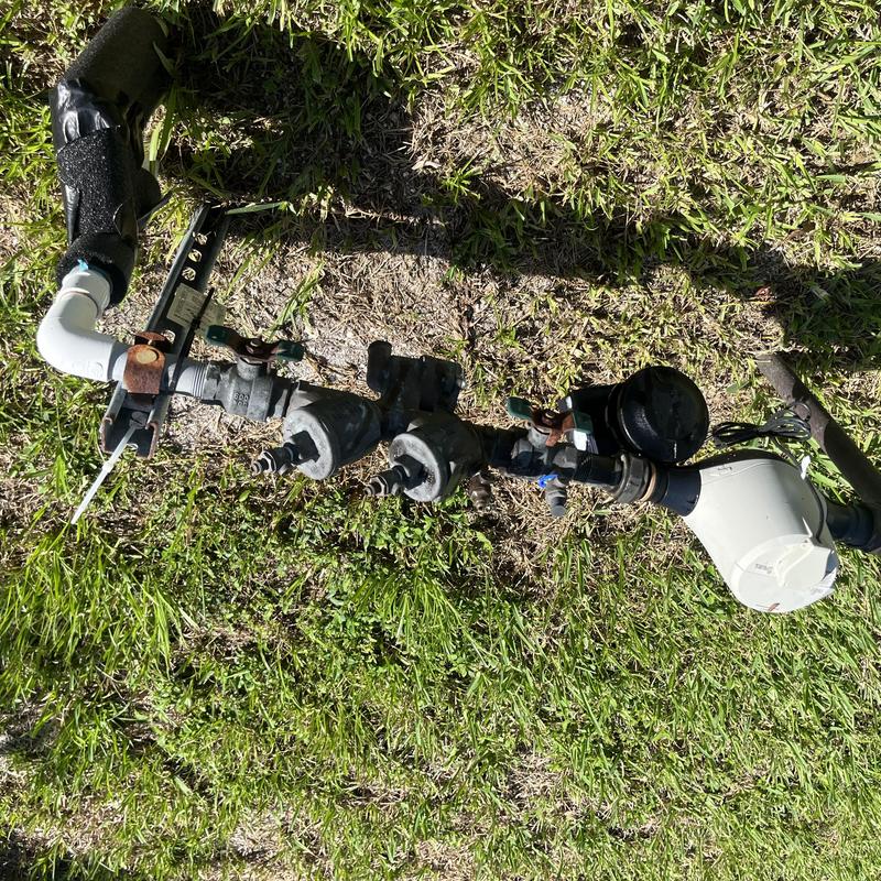 Backflow prevention device on grass with valves