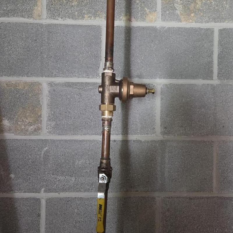 Pressure regulator valve on copper water pipe