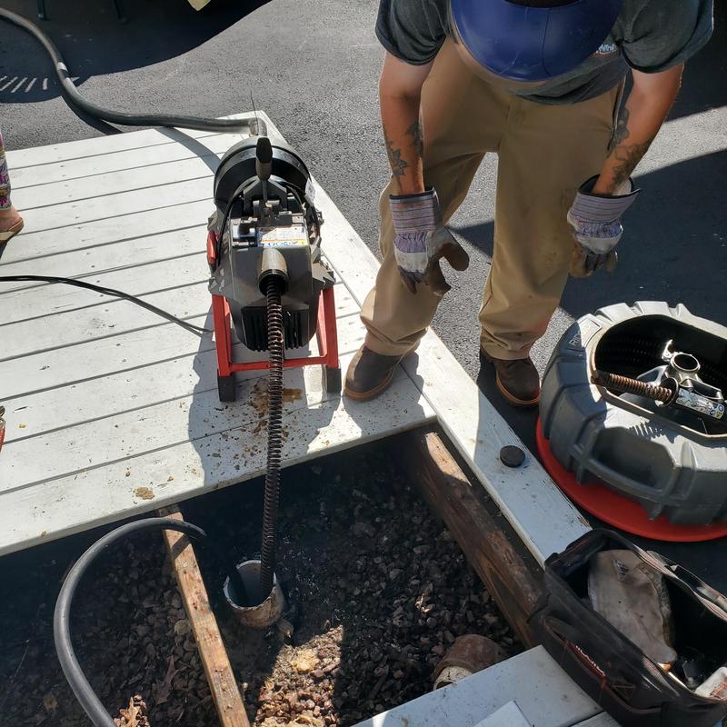 Main sewer drain clearing with auger machine