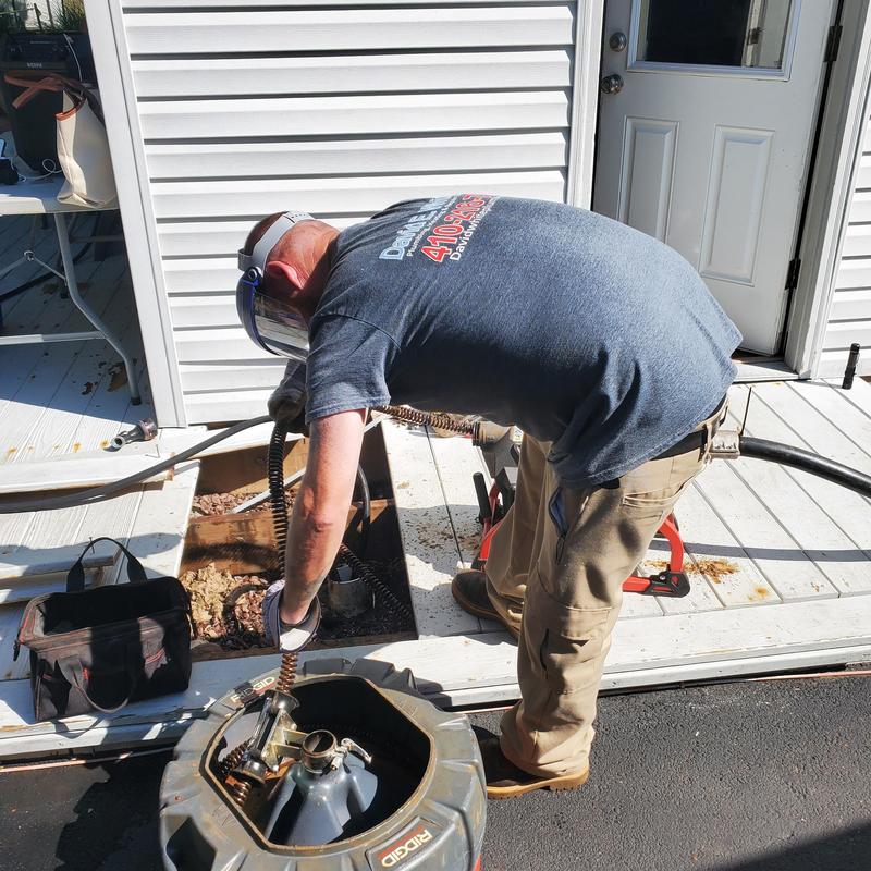 Main sewer drain clearing with rotary auger tool