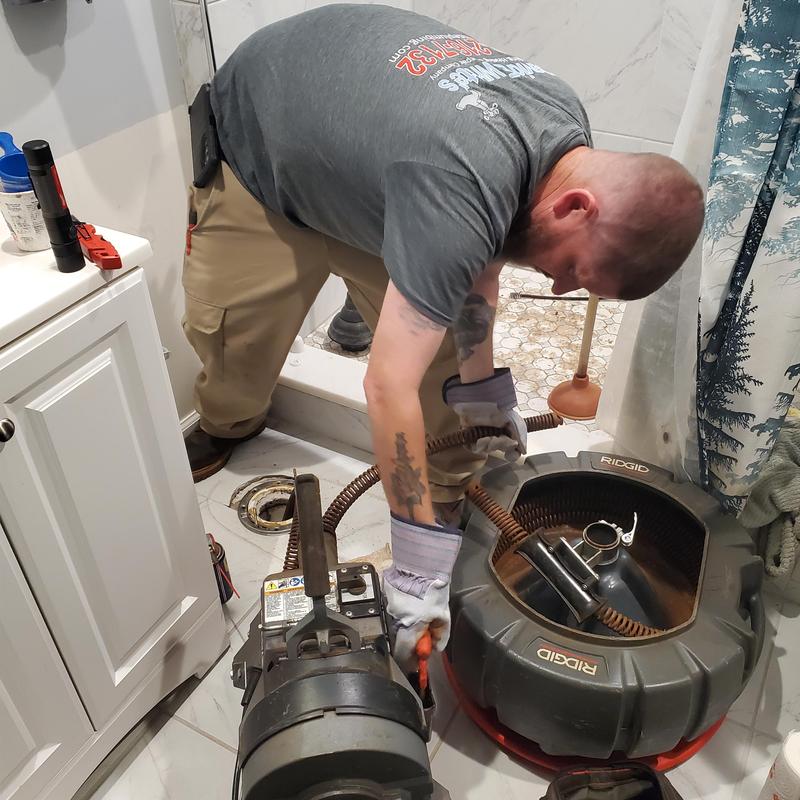 Main sewer drain cleaning machine in bathroom setup