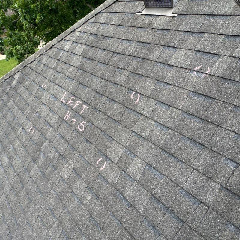 Asphalt shingle roof with hail damage markings