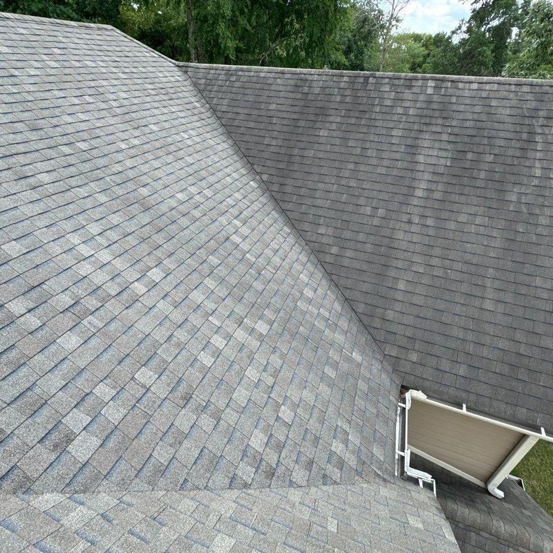 Roof shingles with minor storm damage and displaced areas