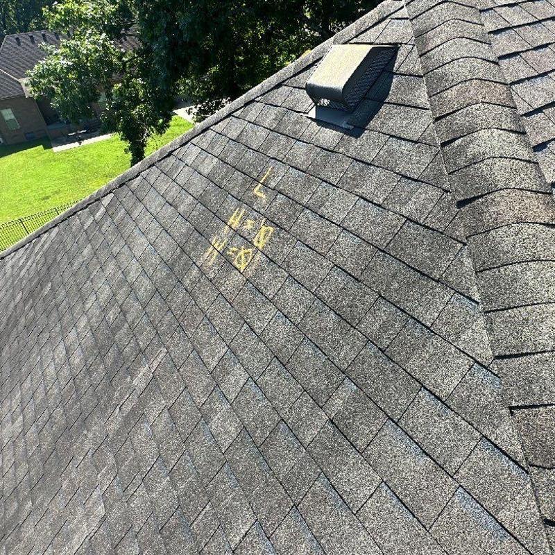 Asphalt shingles with inspection markings on roof