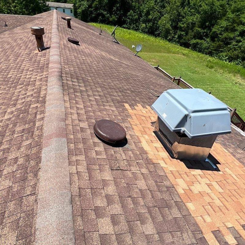 Roof shingles with patch repair near vent covers