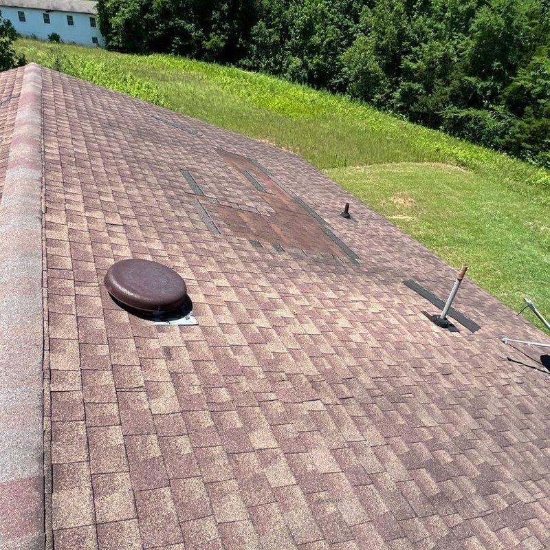 Asphalt shingle roof with hail damage spots
