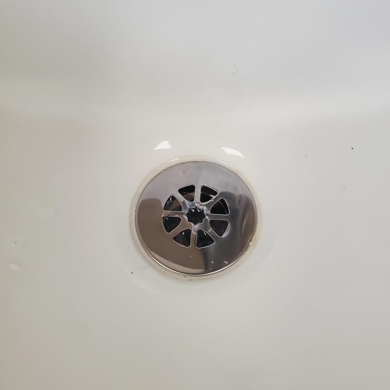Lavatory drain grid installed in white sink basin