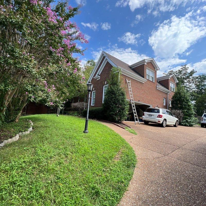 Roof shingles and flashing inspection on brick house