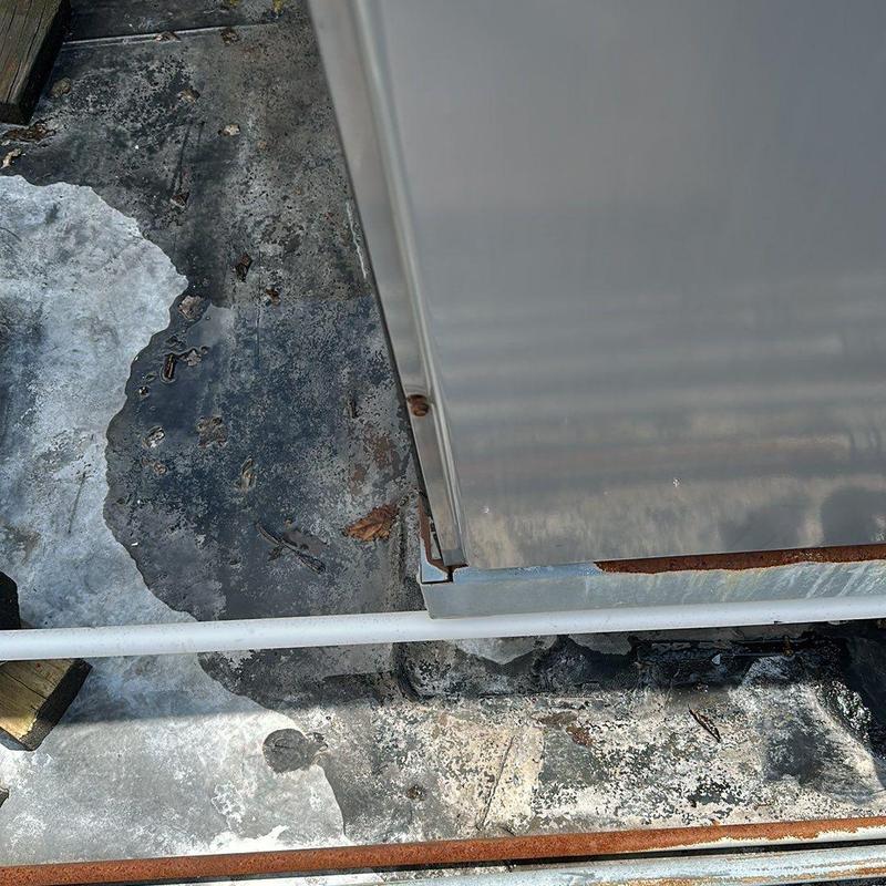 Metal roof edge with rust and weather damage