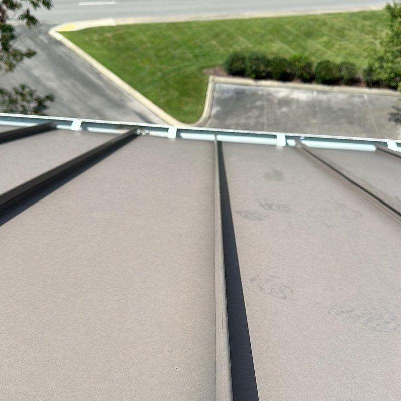 Metal standing seam roof panels with wind damage marks