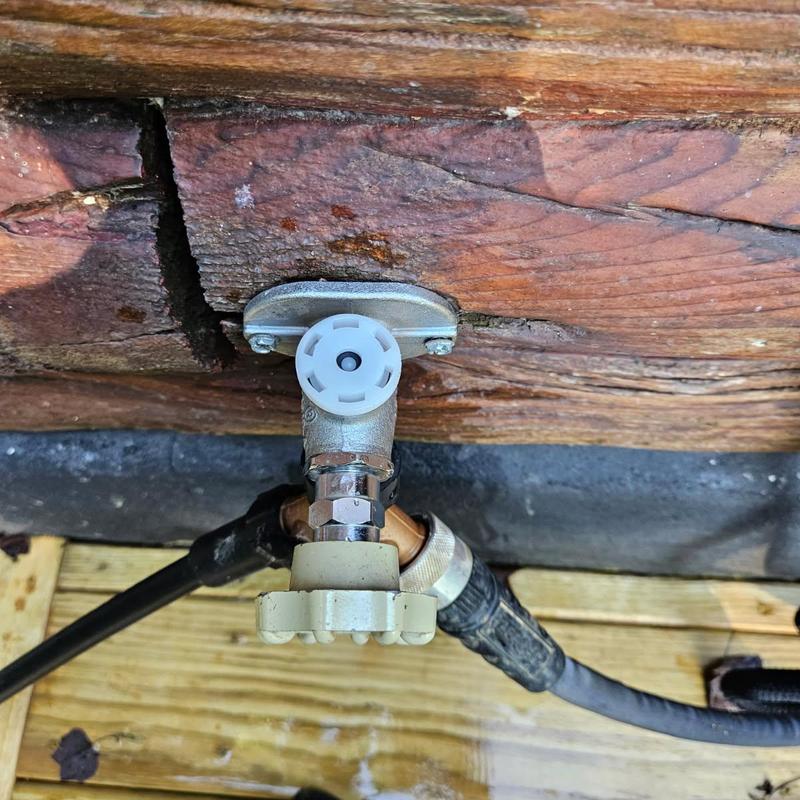 Hose bib with vacuum breaker installed on wood siding