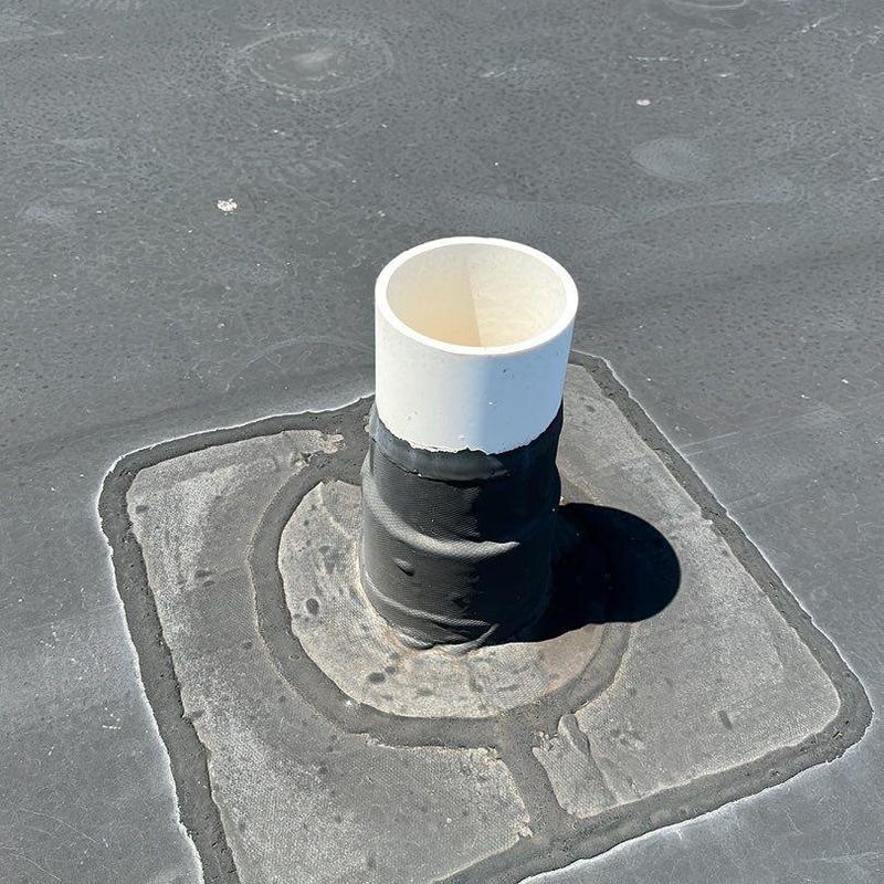 Roof pipe flashing on flat membrane roof