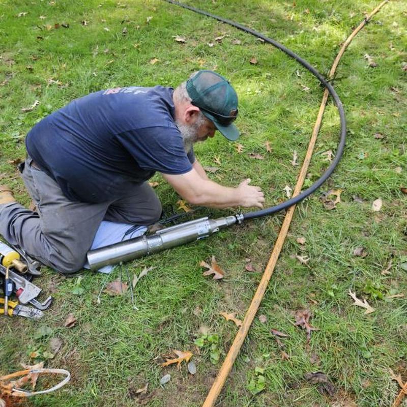 Submersible well pump installation with new water line