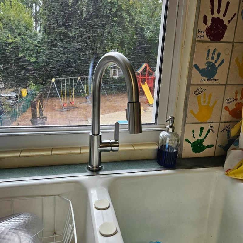 Kitchen faucet with pull-down sprayer in window sill