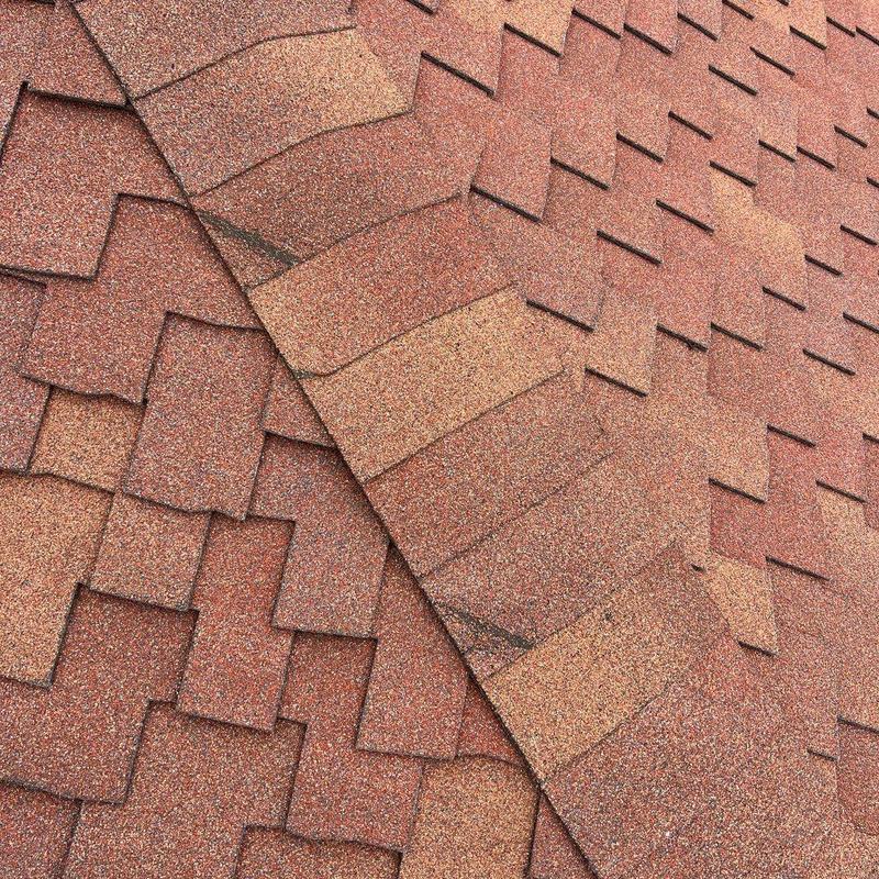 Asphalt shingles with cracked and damaged areas