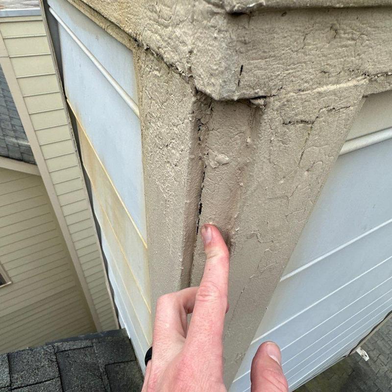 Exterior wood trim with paint cracking and damage